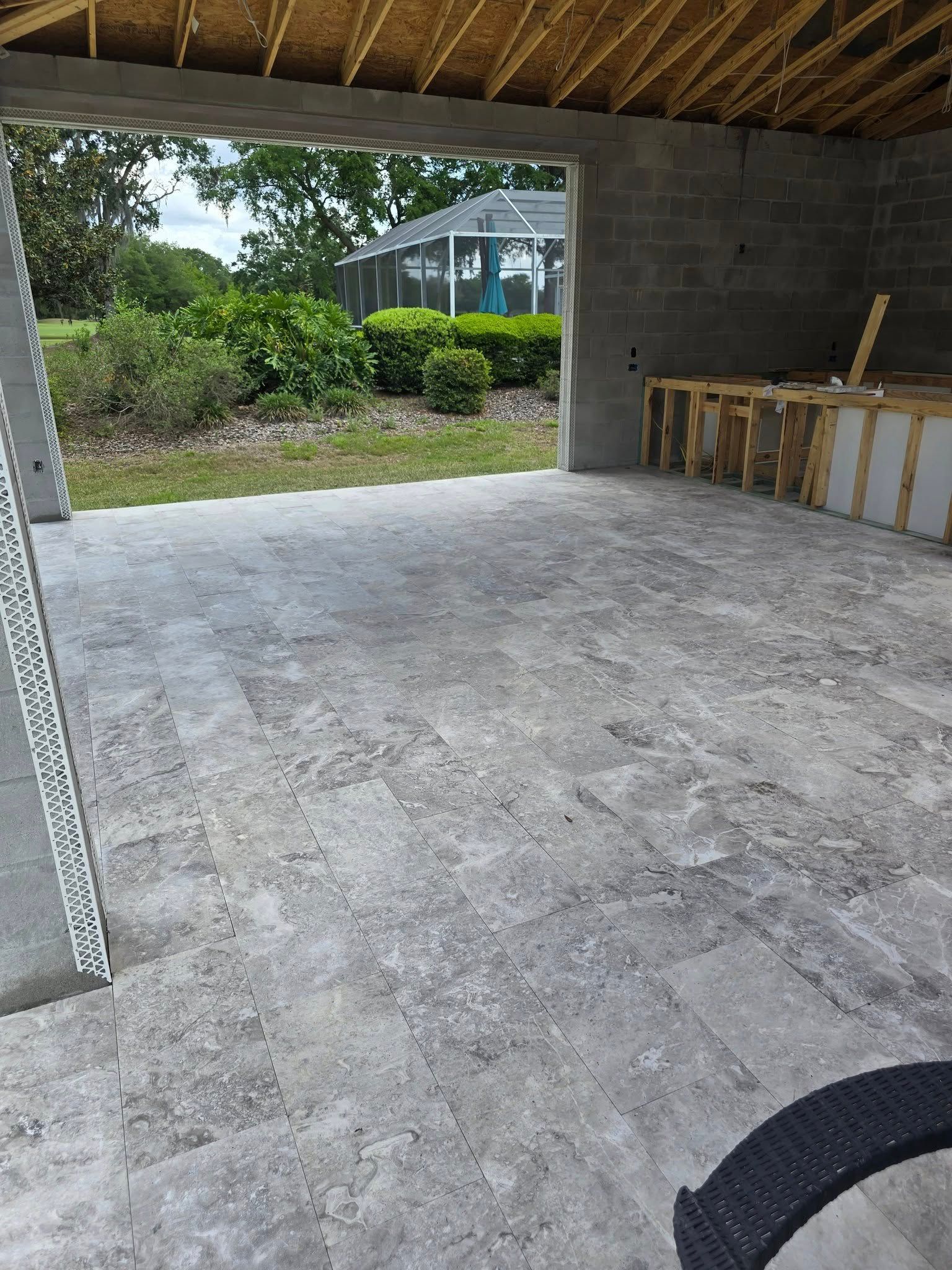 A patio with a gazebo in the background is being built.