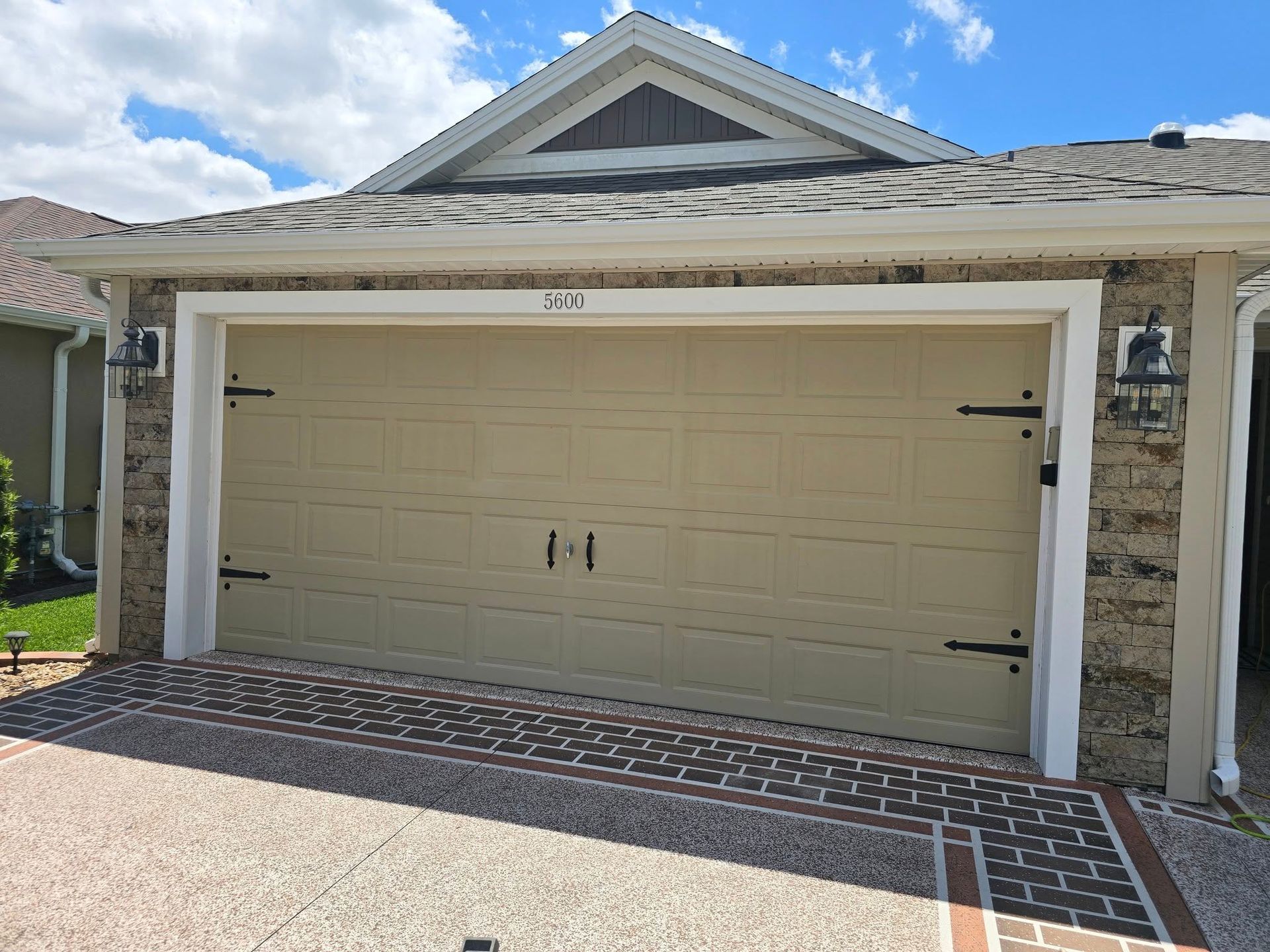 A garage door is sitting in front of a house.