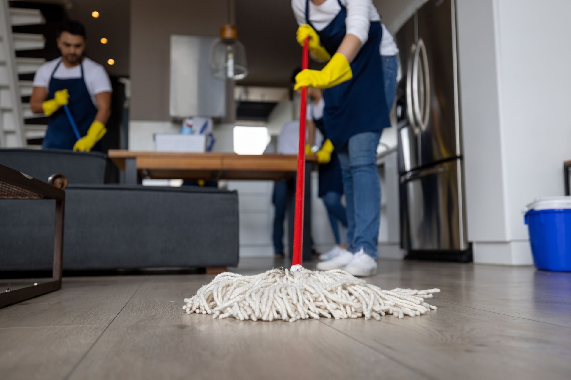 Close-up on a professional cleaner mopping the floor.