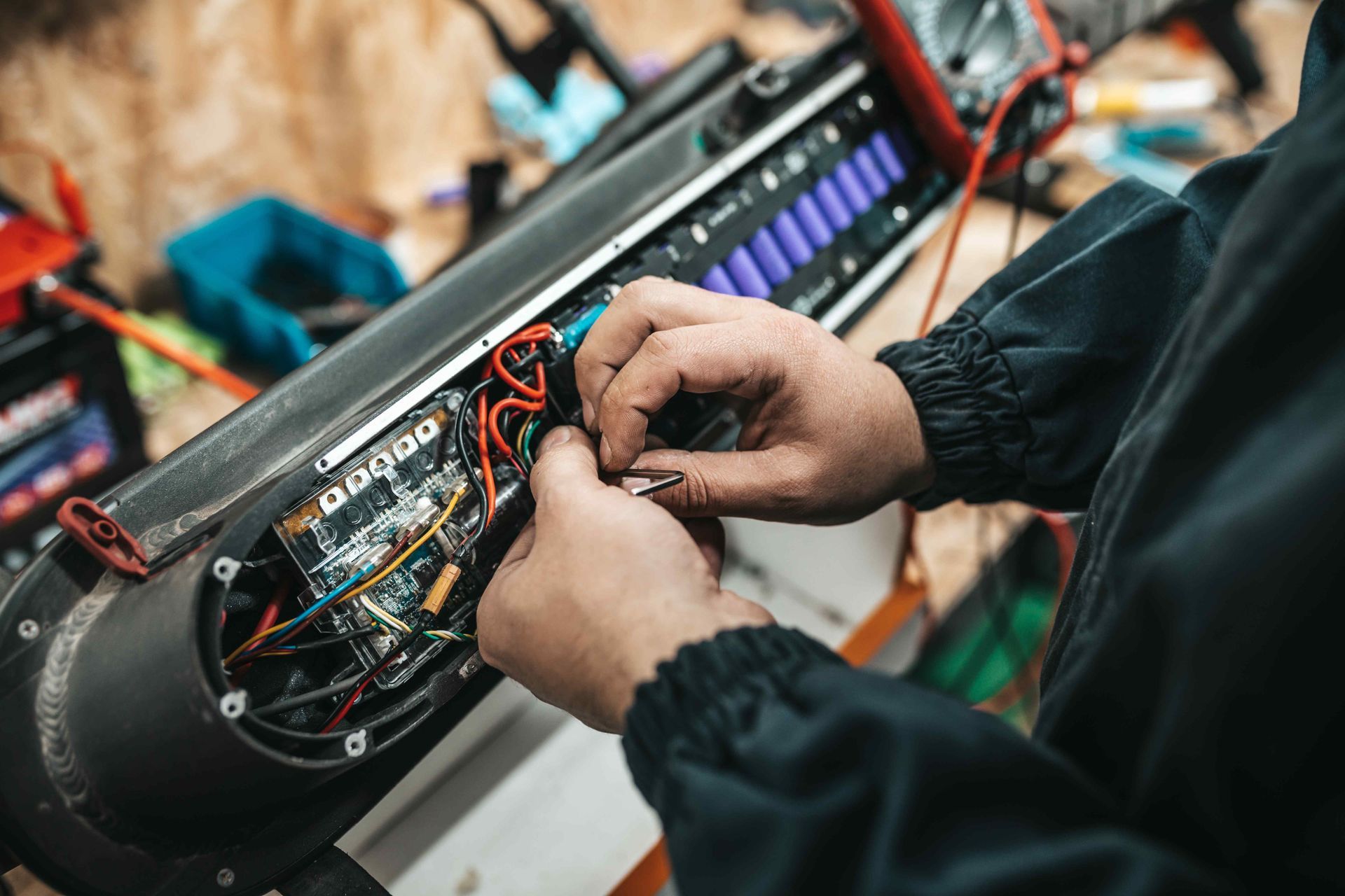 zoom in on hands wiring a piece of equipment