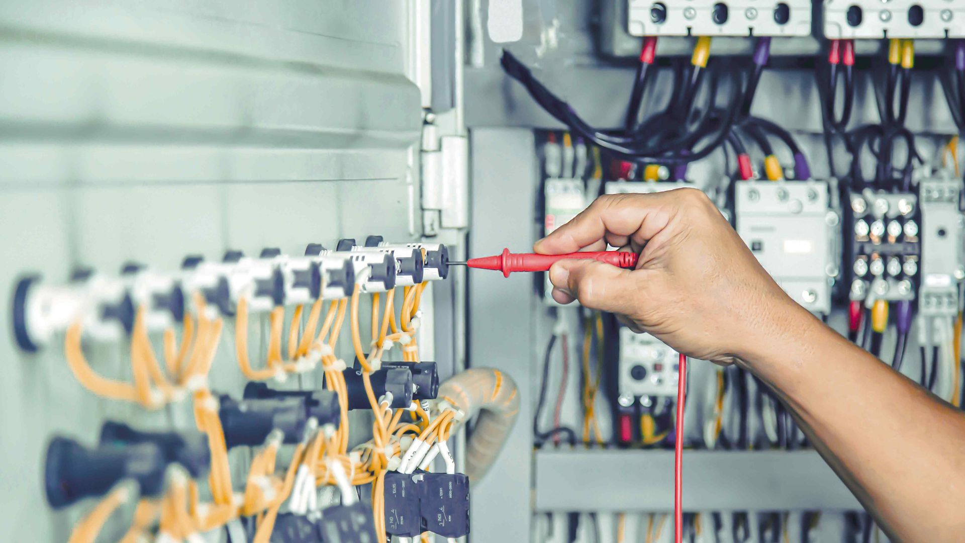 Zoom in on a hand using a tool  to repair a circuit breaker