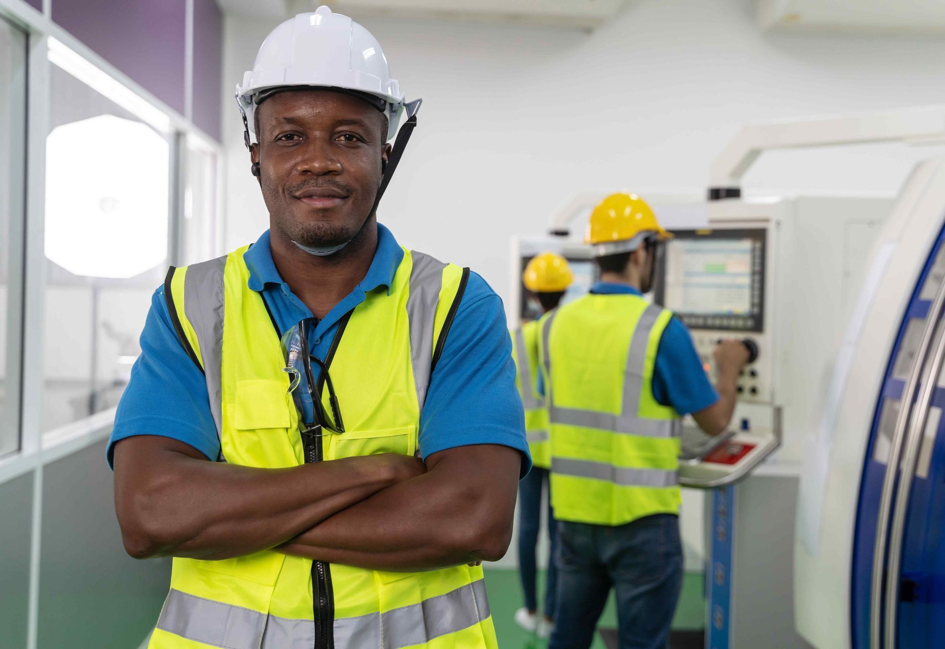 electrician with arms folded in front of him smiling