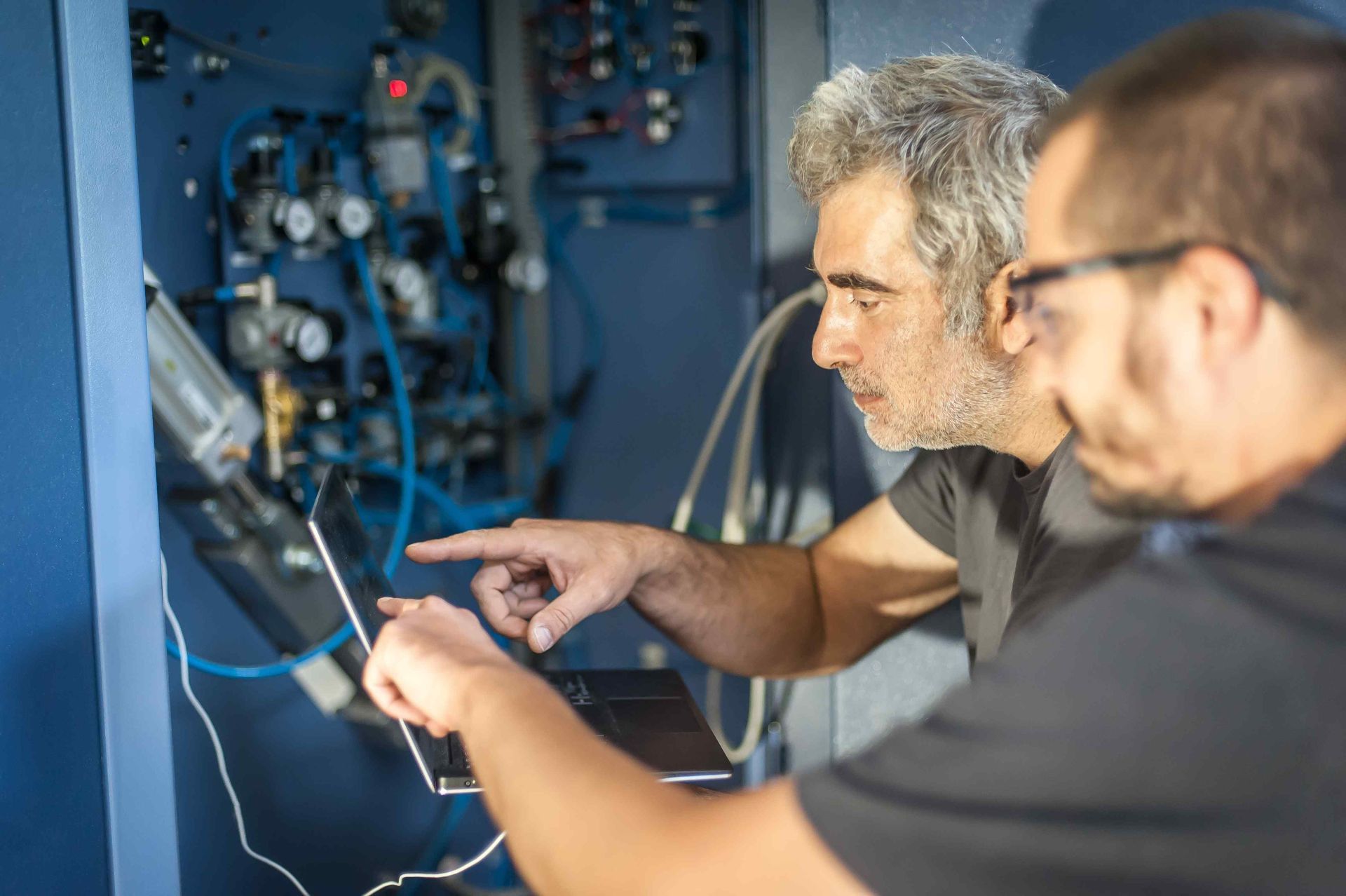 licensed electricians inspecting electrical panel 