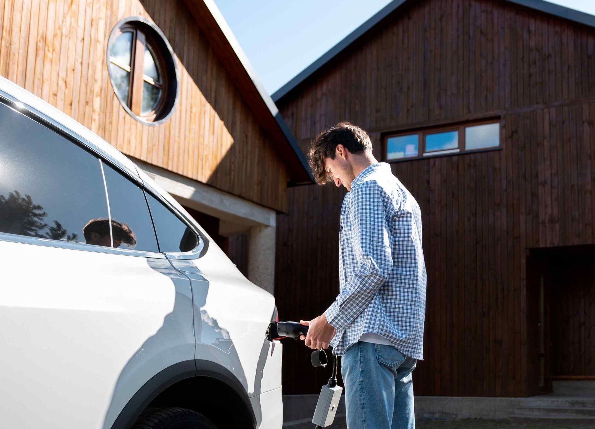 man charging car at home