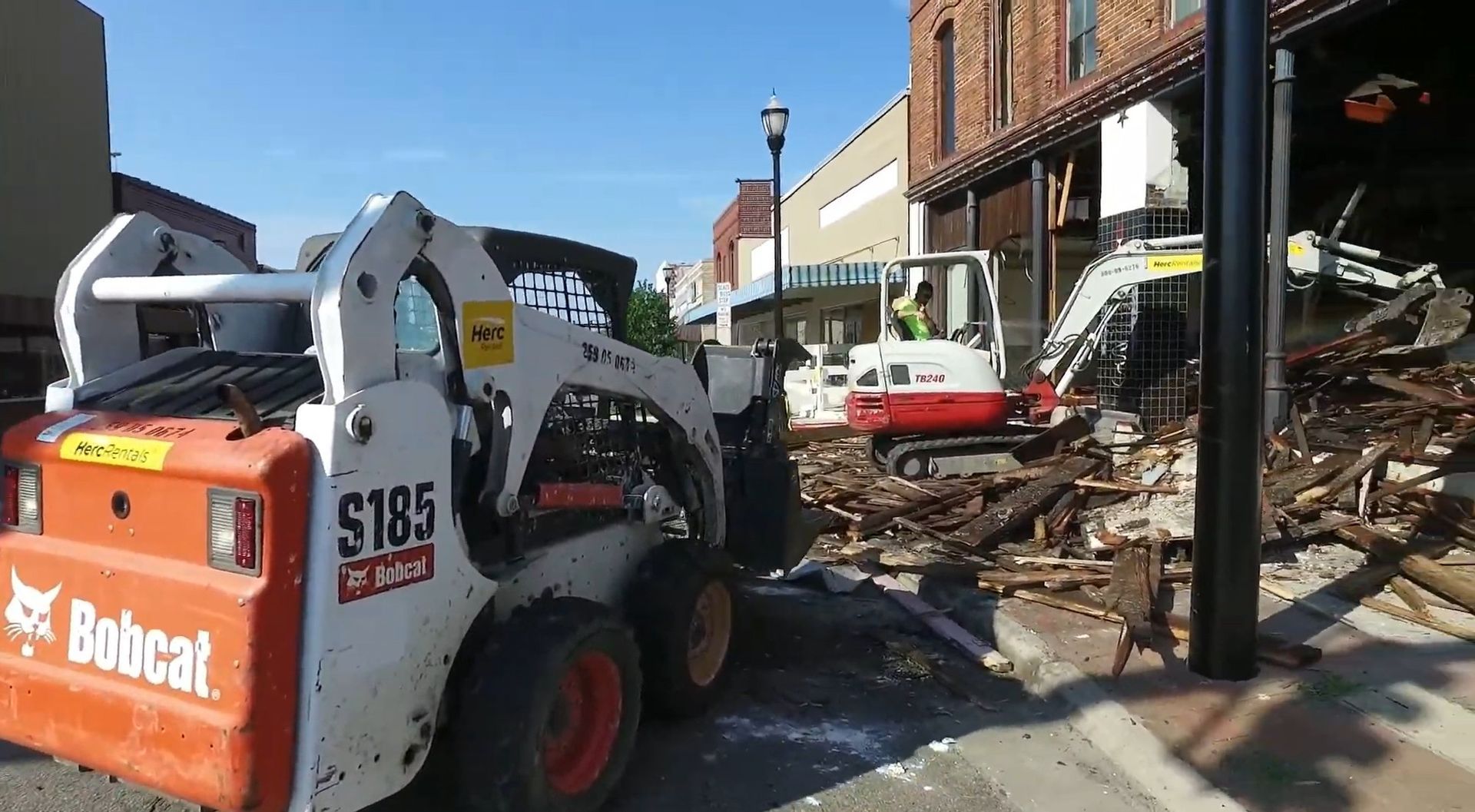 A bobcat skid steer is parked on the side of the road