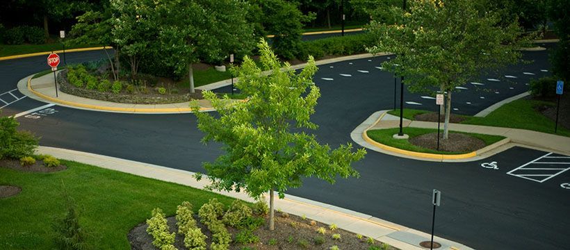 An aerial view of a parking lot with trees and a stop sign.