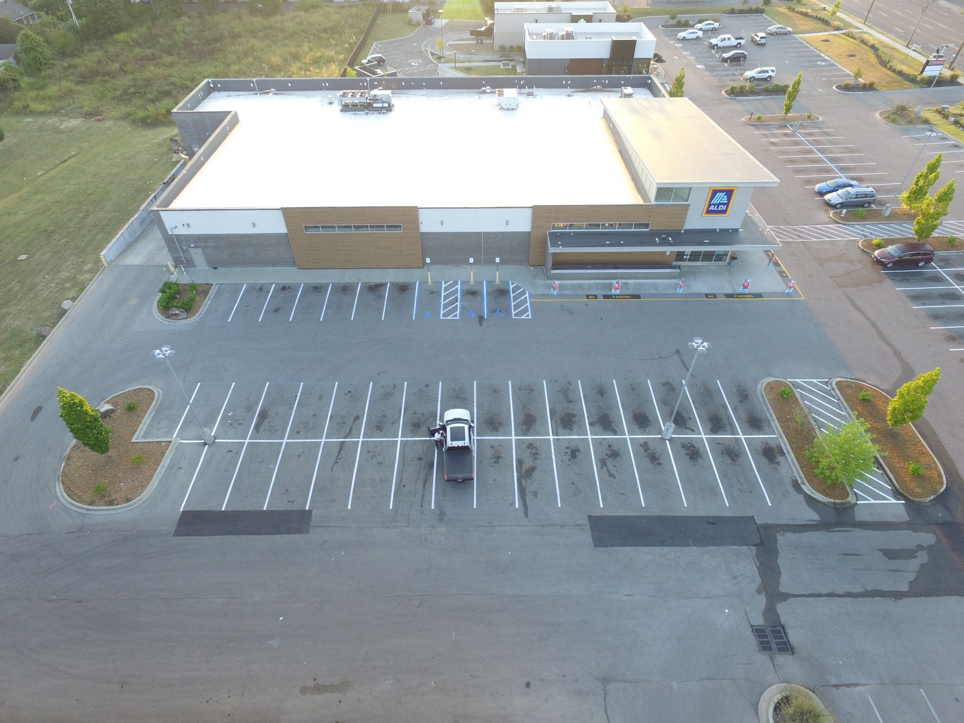An aerial view of a mall with lots of parking spaces.