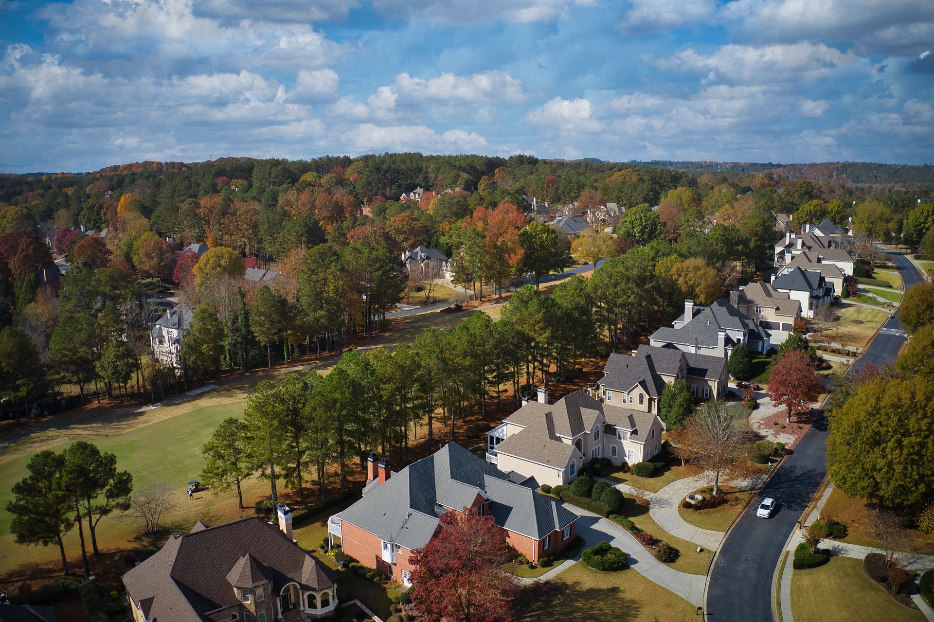An aerial view of a residential area with houses and trees.