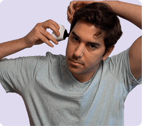 Man applying a topical solution to his scalp.