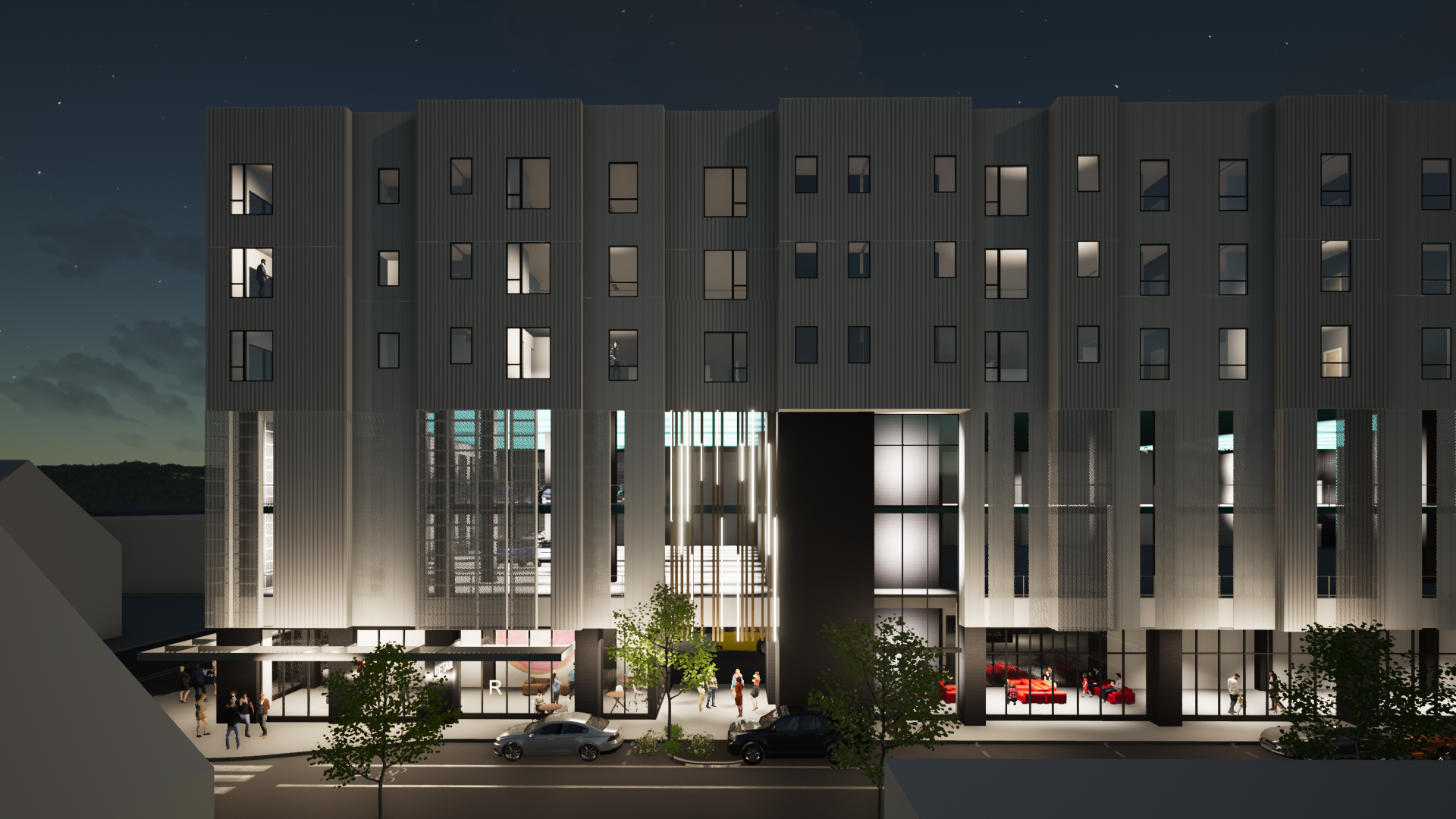 A large building with a lot of windows is lit up at night.