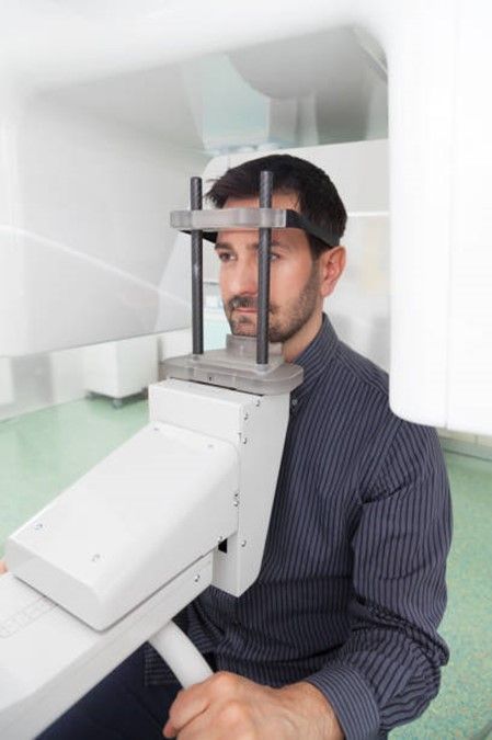 A man is getting an x-ray of his head.