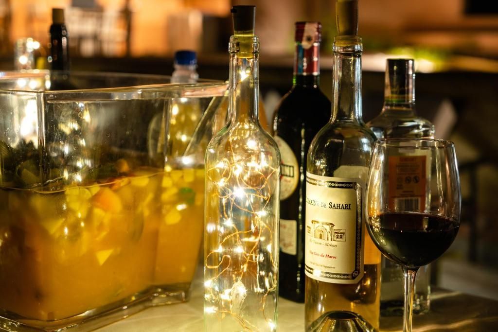 A table topped with bottles of wine and glasses of wine.