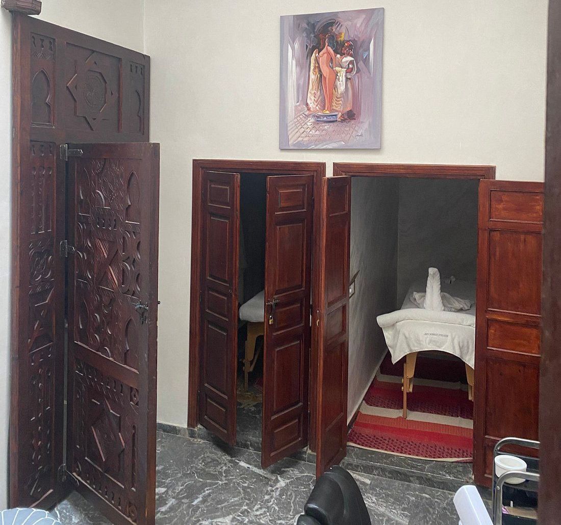 A room with wooden doors and a painting on the wall