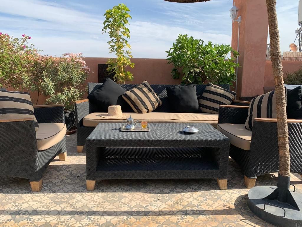 A patio with a couch , chairs and a coffee table