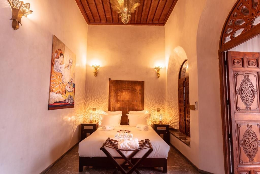 A bedroom with a bed , nightstands , and a door.