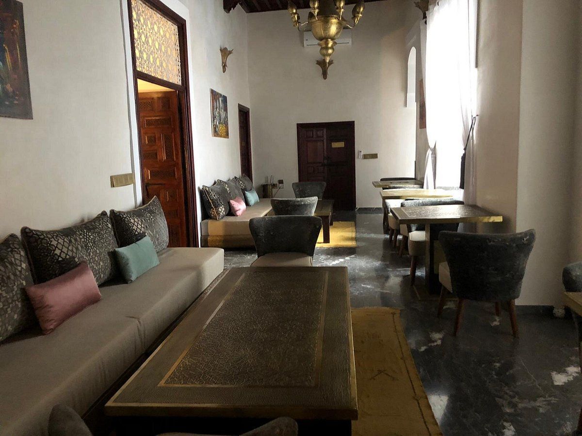 A living room with a couch a table and chairs