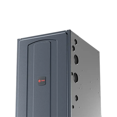 Gray Trane furnace against a white background; side view showing air duct ports.
