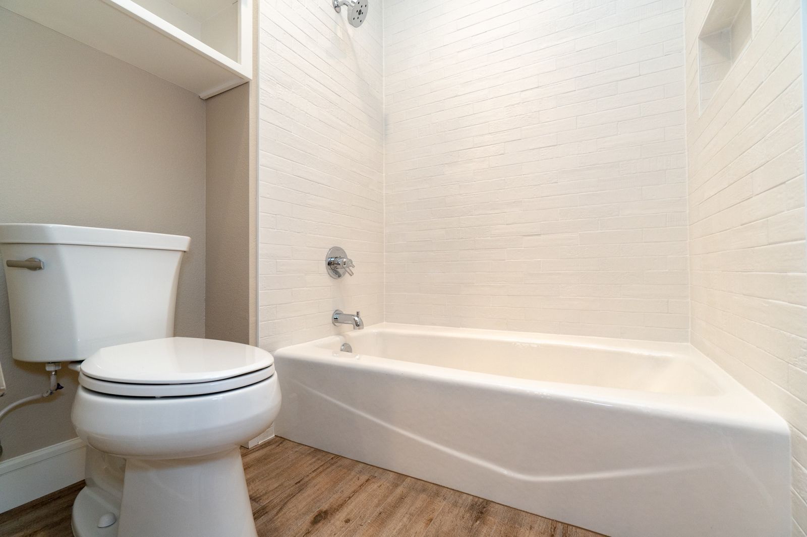 A bathroom with a toilet and bathtub in it