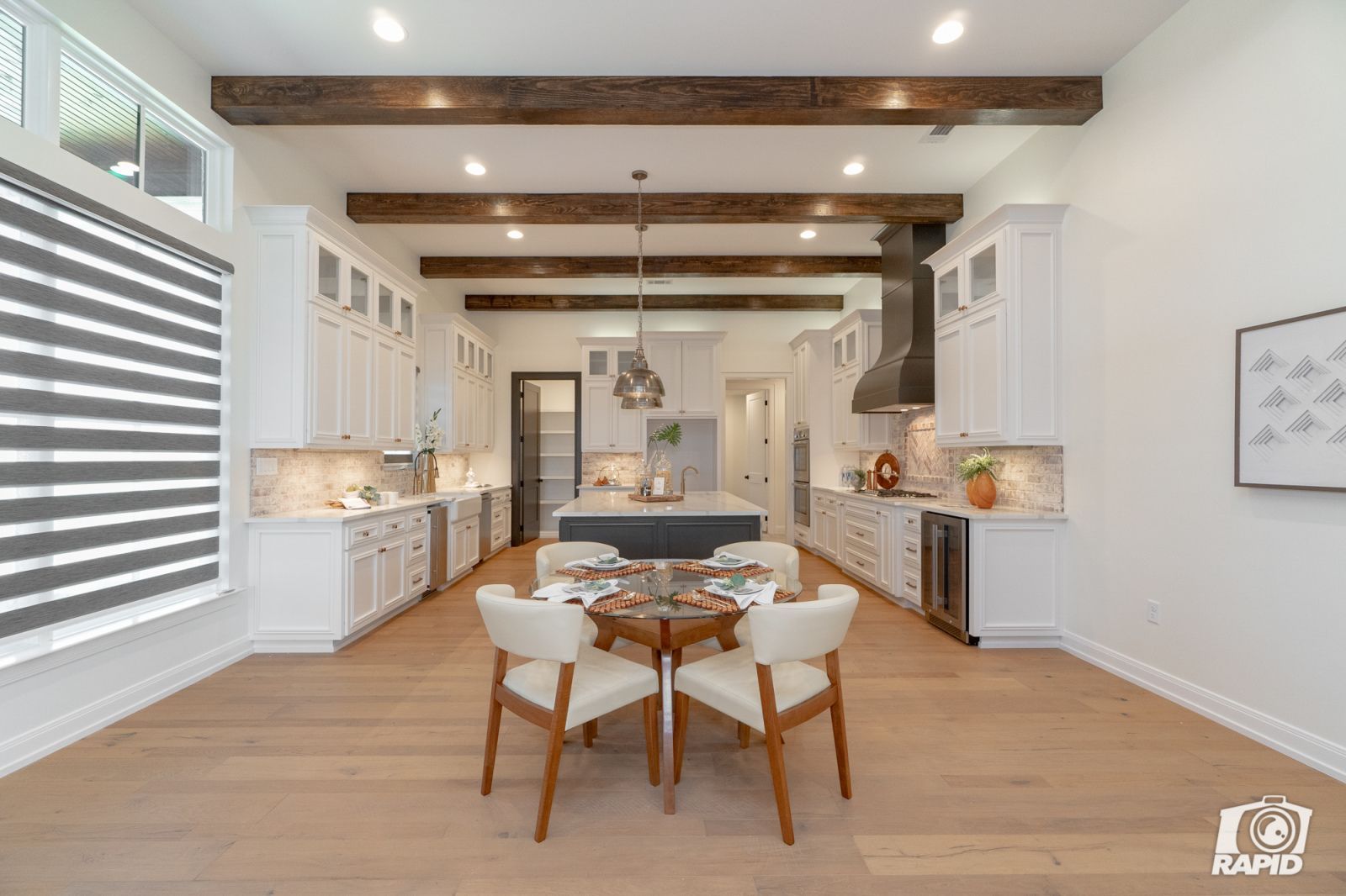 A kitchen with a table and chairs in it