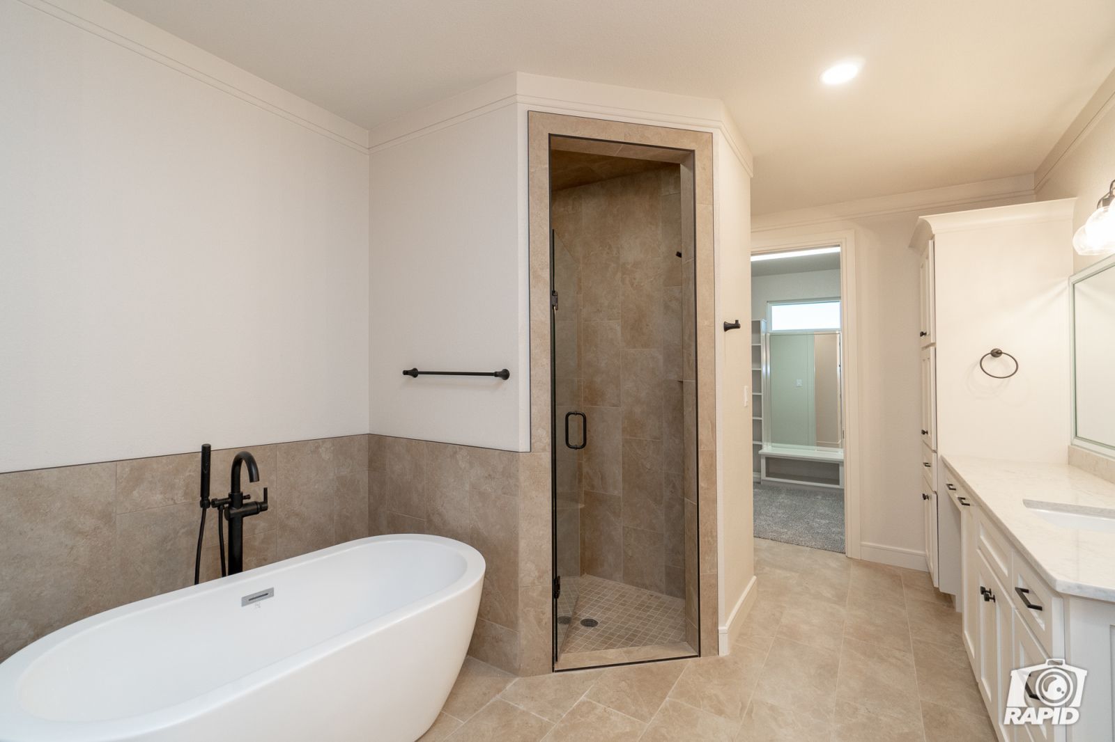 A bathroom with a bathtub and a walk in shower