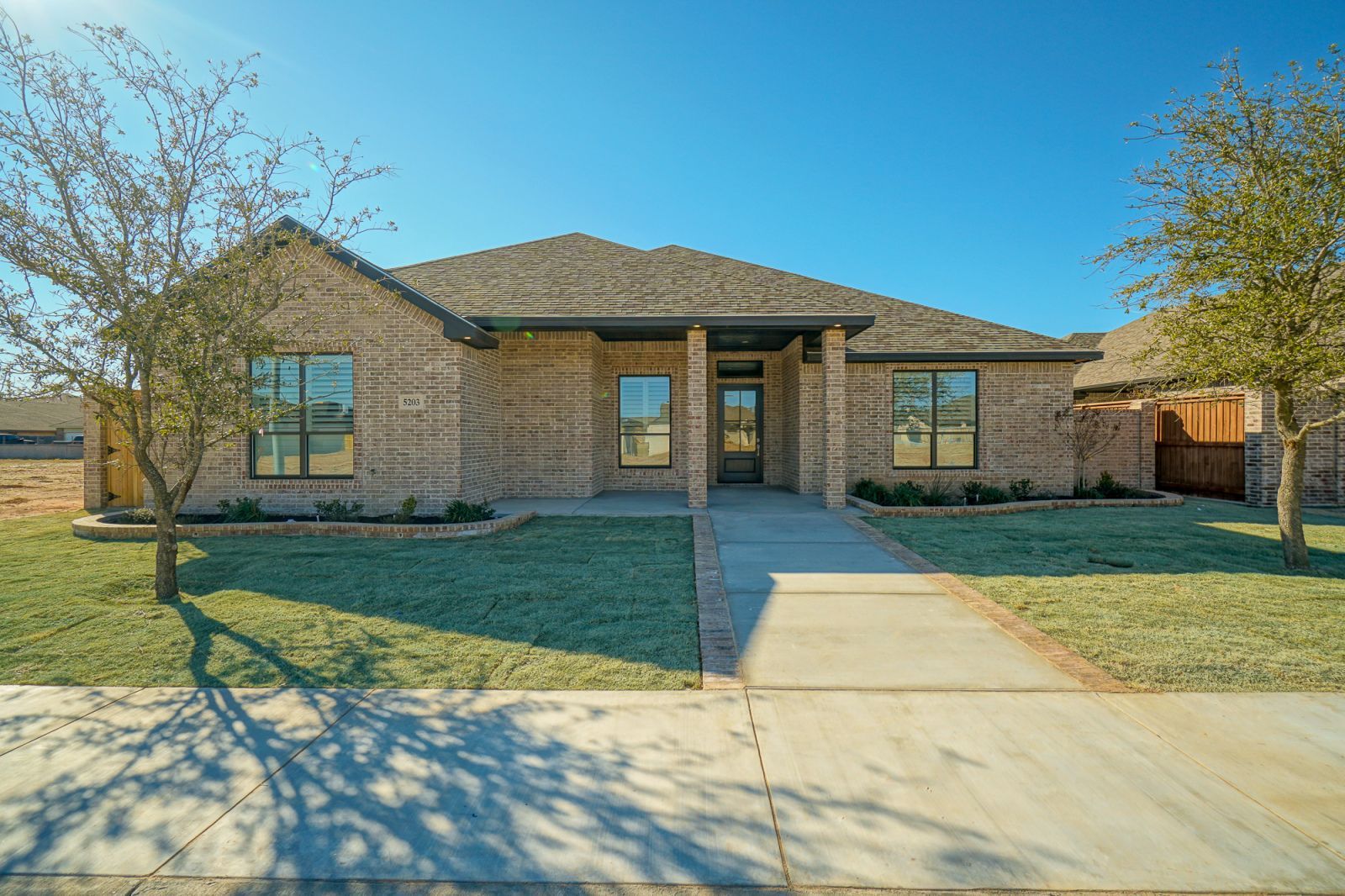 A brick house with a walkway leading to it