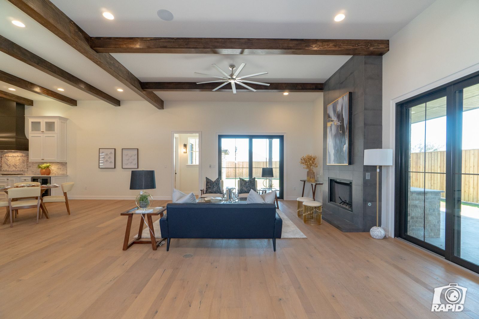 A living room with a blue couch and a fireplace