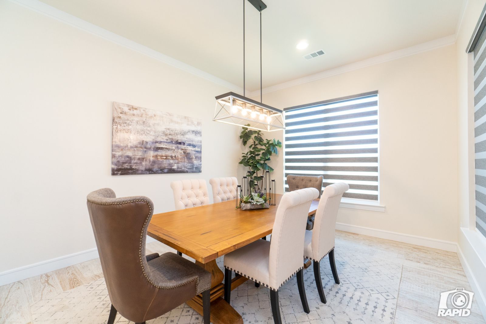 A dining room with a wooden table and chairs