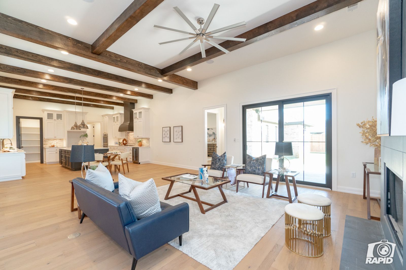 A living room with a blue couch and a ceiling fan