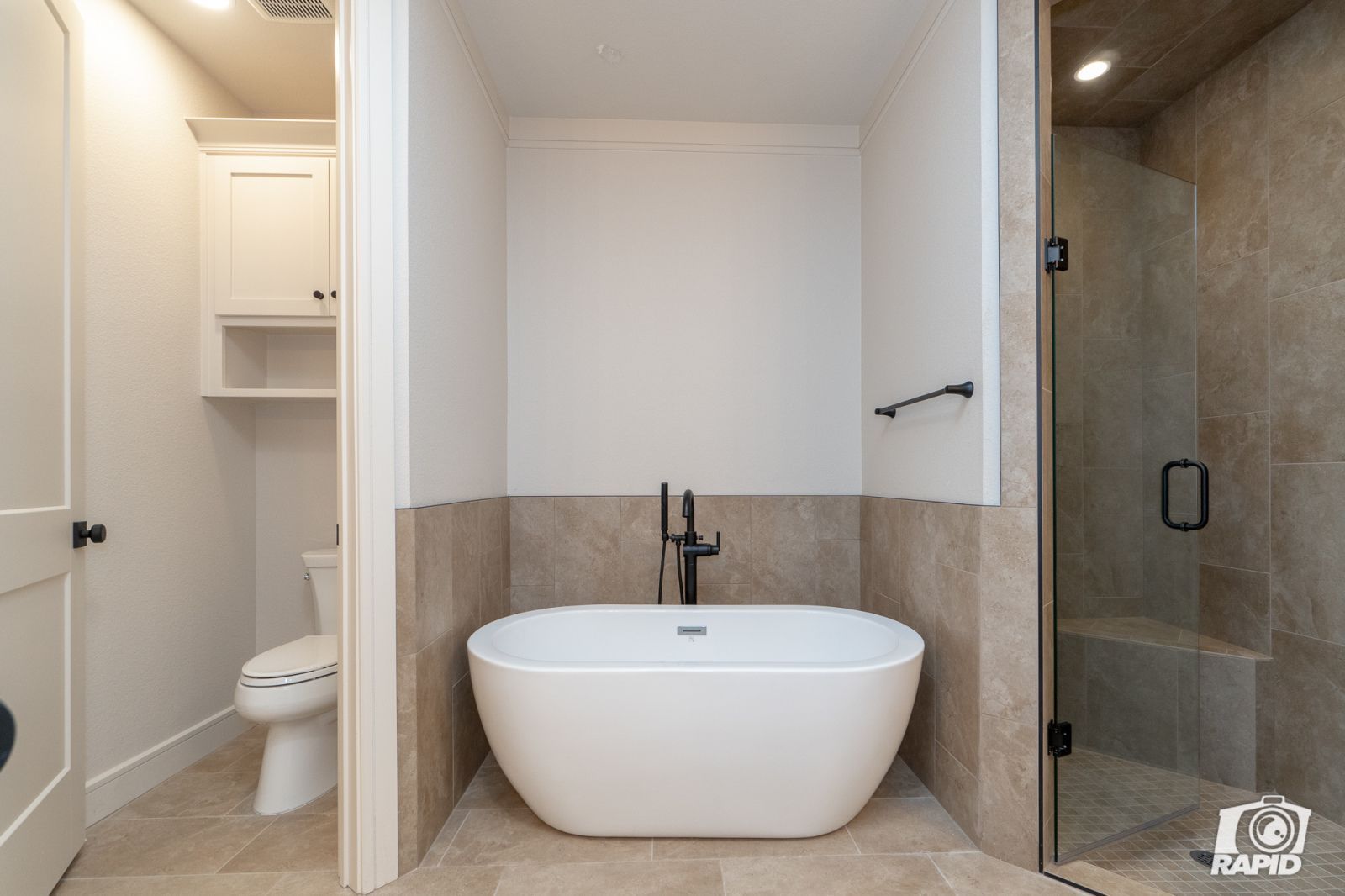 A bathroom with a bathtub and a toilet