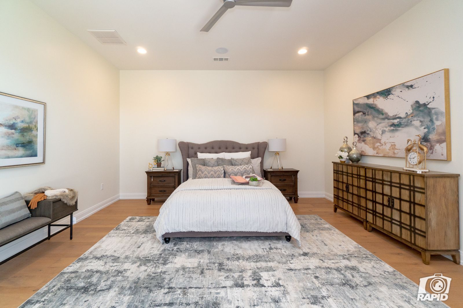 A bedroom with a large bed and a rug