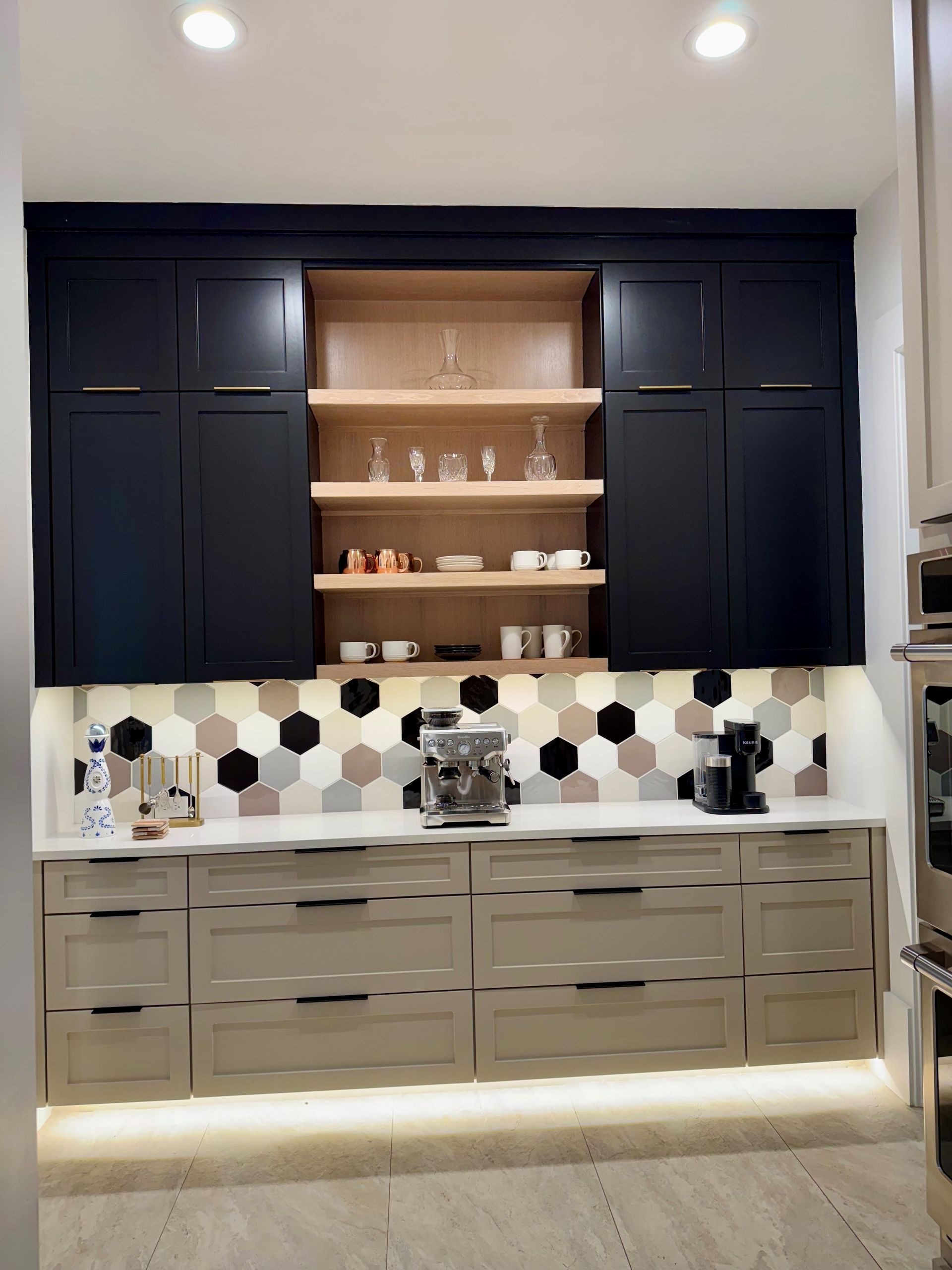 A kitchen with white cabinets and stainless steel appliances.
