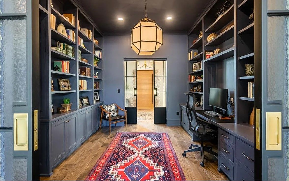 A dining room with a table and chairs and a chandelier.