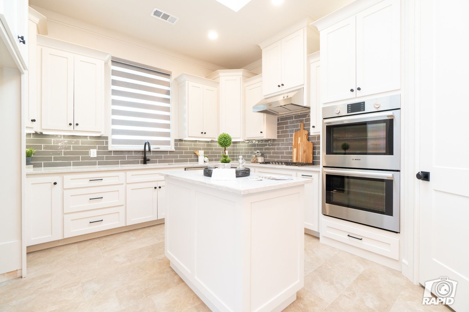 A kitchen with white cabinets and stainless steel appliances