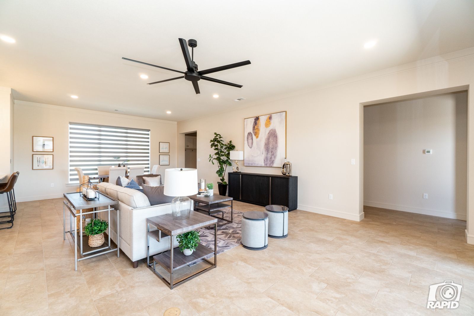 A living room with a ceiling fan and a couch