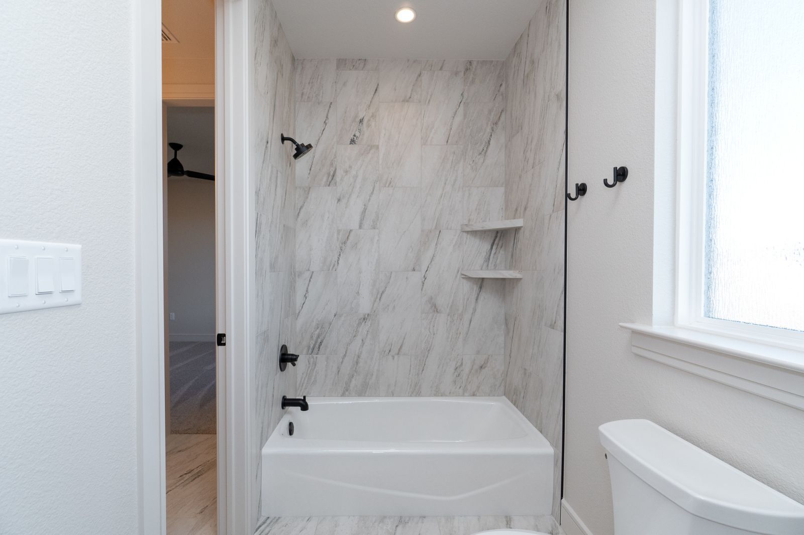 A bathroom with a bathtub and a toilet