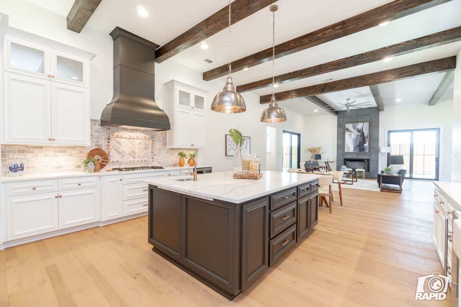 A kitchen with a large island and white cabinets