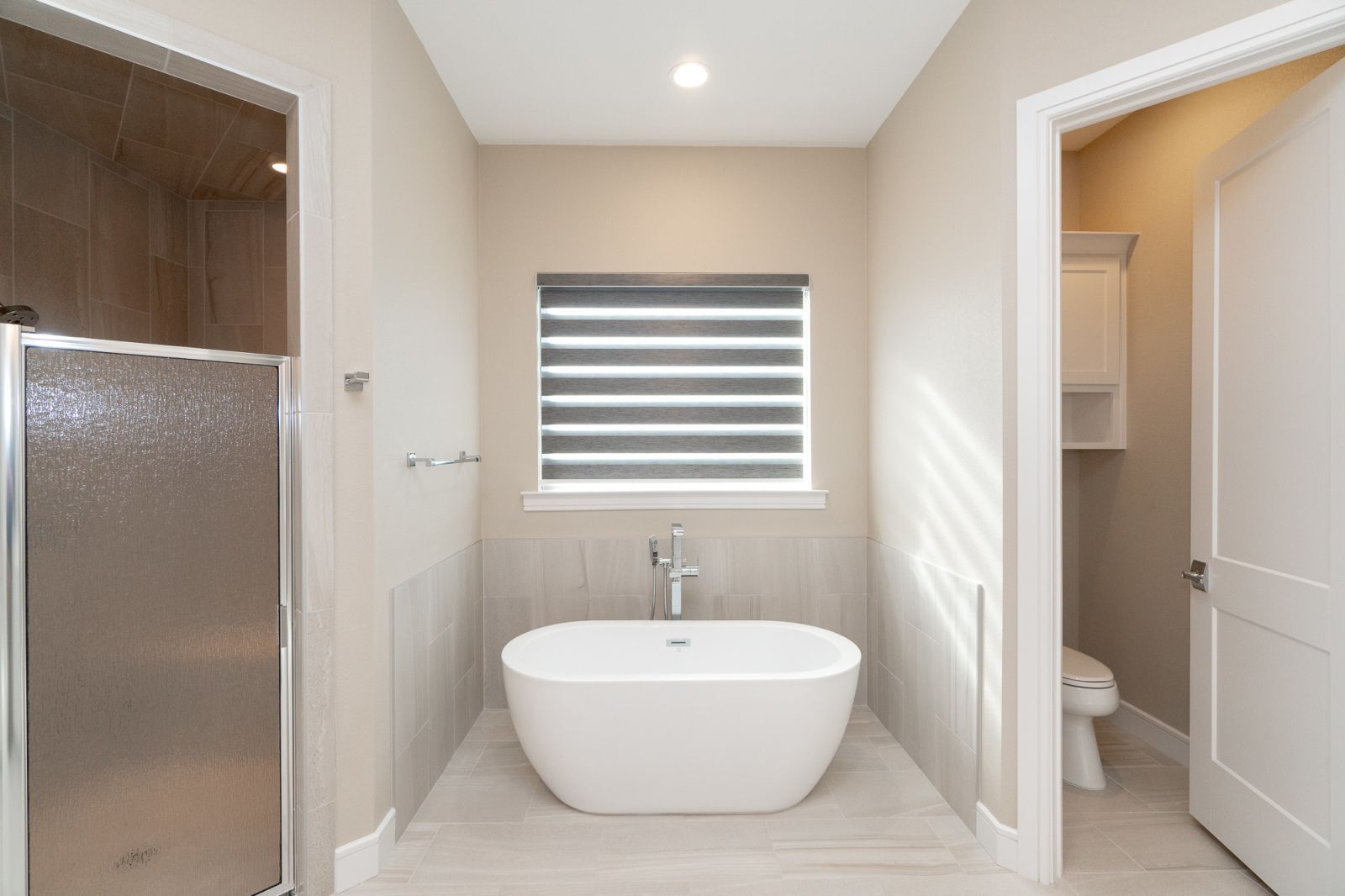 A bathroom with a bathtub and a window