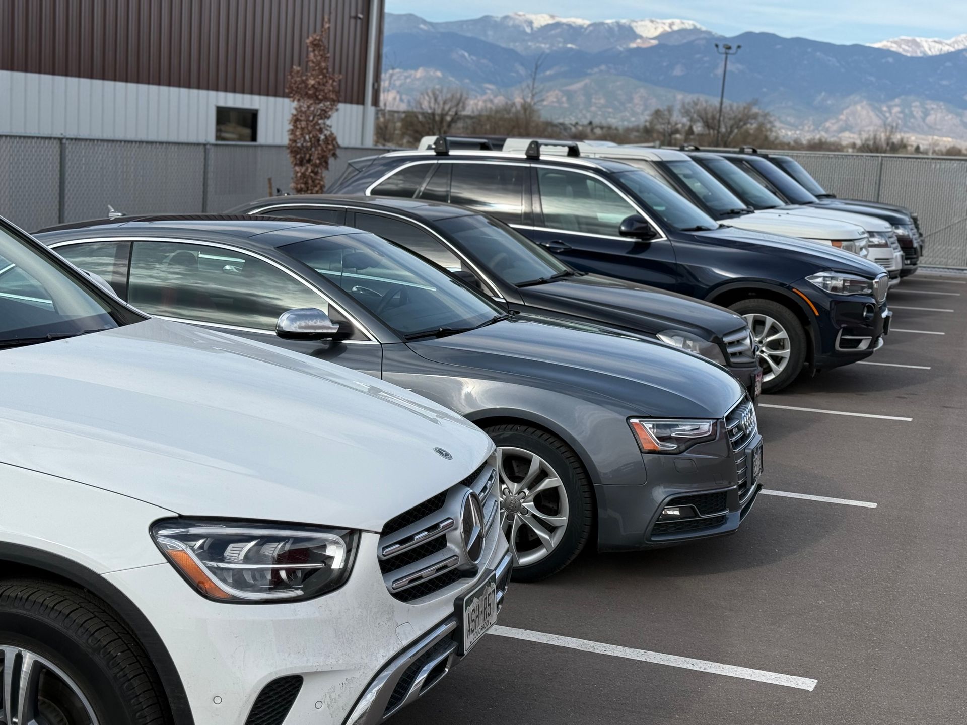 Row of parked luxury cars | PPR Automotive