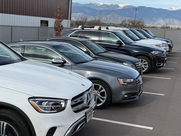 A row of luxury cars parked in a lot | PPR Automotive
