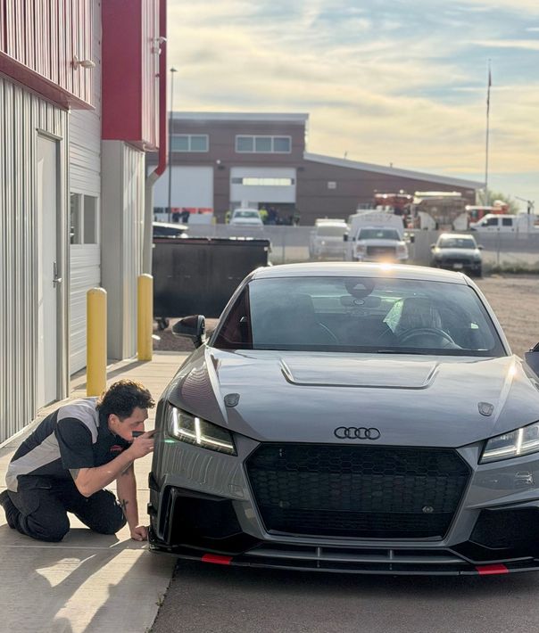 Gray Audi A7 sedan with hood open on a red car lift inside a garage.  | PPR Automotive