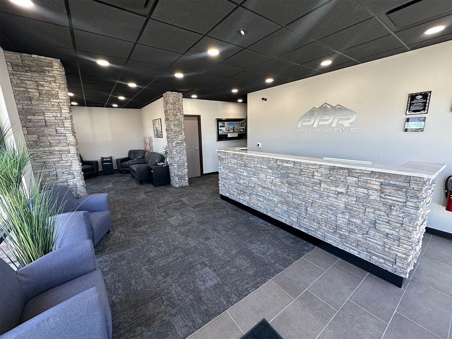 Gray Audi A7 sedan with hood open on a red car lift inside a garage. | PPR Automotive