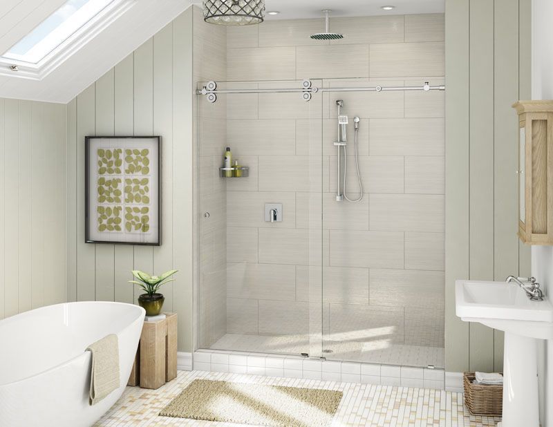 Bathroom with shower and bathtub. Light-colored walls, glass shower door, white fixtures, and a rug.