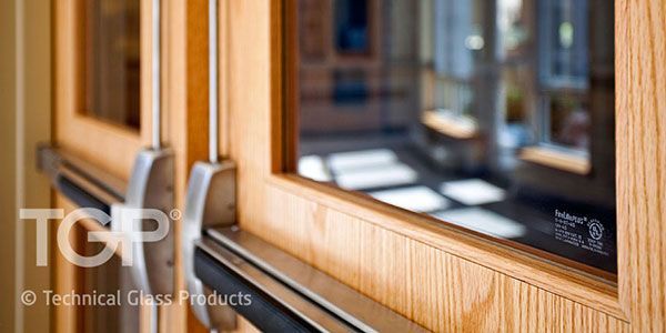 Wooden doors with push bars and glass window.