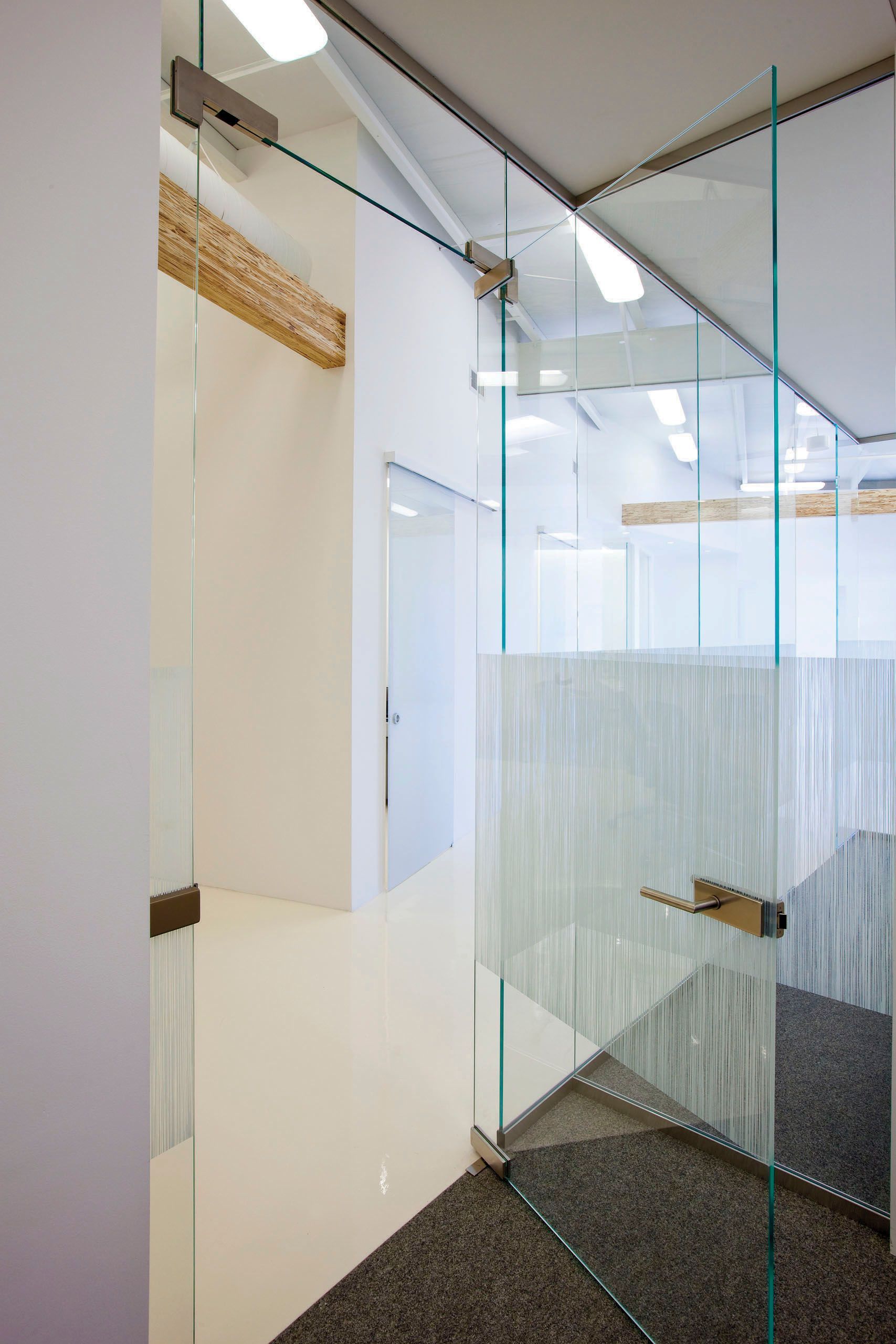 Glass office doors, one frosted, with a white interior.