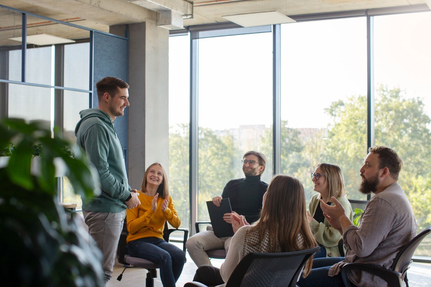 A group of people are sitting around a table in a room.