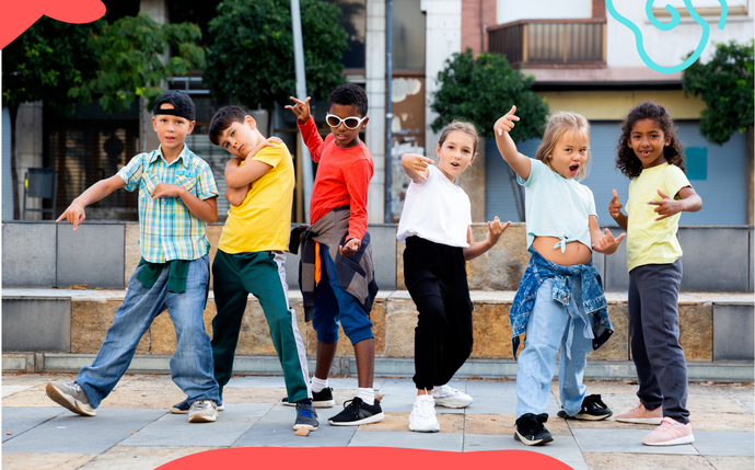 a group of young children are dancing together on a sidewalk .