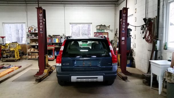 car on a Lift in Shop | Chris Autobody | Salisbury, MA