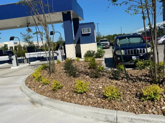 A black jeep is parked in front of a gas station