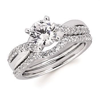 A diamond ring is sitting on a wooden table