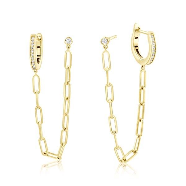 A gold necklace and ring on a white surface